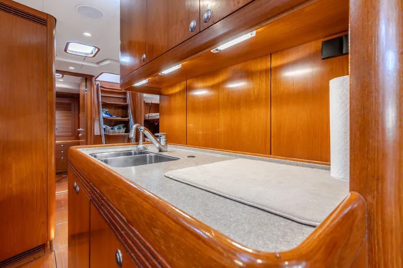 Slide: The Image of Luxurious wooden kitchen interior of 2005 Nautor Swan 82S yacht with sink and countertop. - 22