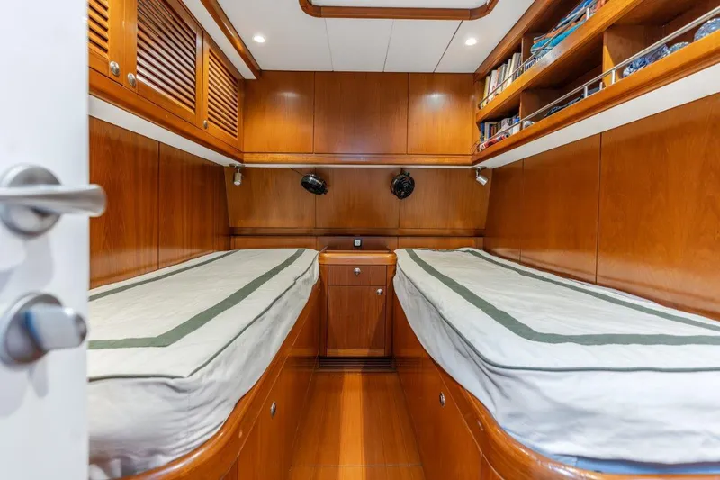 Slide: The Image of Twin cabin in 2005 Nautor Swan 82S yacht with wooden interiors and built-in storage. - 28