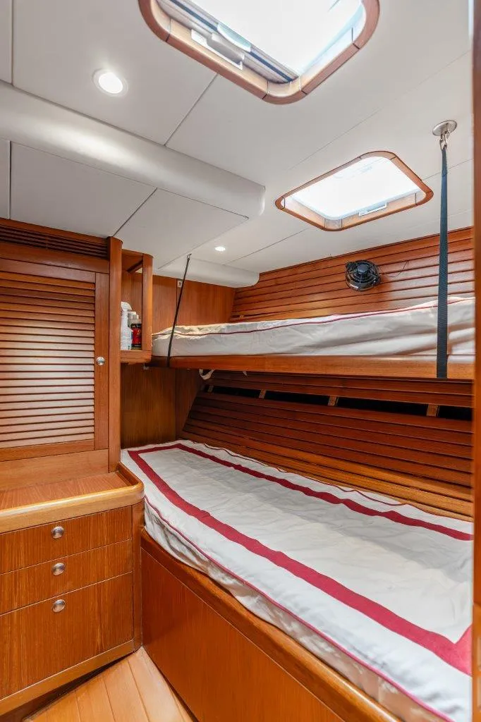 Slide: The Image of Interior cabin of 2005 Nautor Swan 82S yacht with wooden bunk beds and storage. - 32
