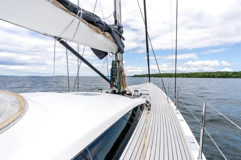 Slide: The Image of Nautor Swan 82S 2005 yacht sailing on open water with clear skies. - 4