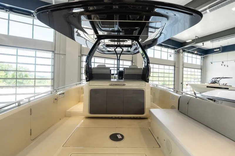 Slide: The Image of 2024 Invictus GT320S boat interior with sleek design and modern features in a showroom. - 13
