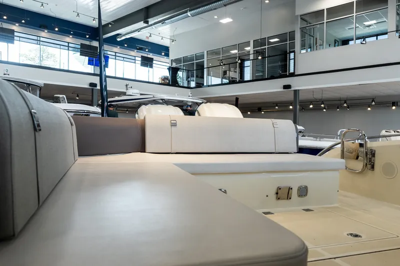 Slide: The Image of 2024 Invictus GT320S luxury yacht interior with modern seating in showroom. - 16