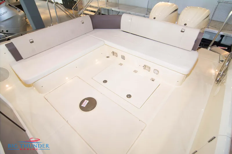Slide: The Image of 2024 Invictus GT320S boat interior with white seating and storage compartments. - 18