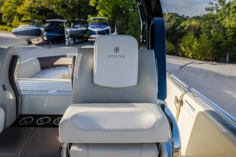 Slide: The Image of 2024 Invictus GT320S boat interior with luxurious seating and cup holders. - 17
