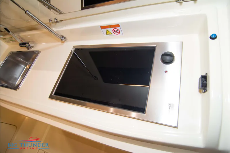 Slide: The Image of Invictus GT320S 2024 yacht kitchen with modern stovetop and sink. - 23