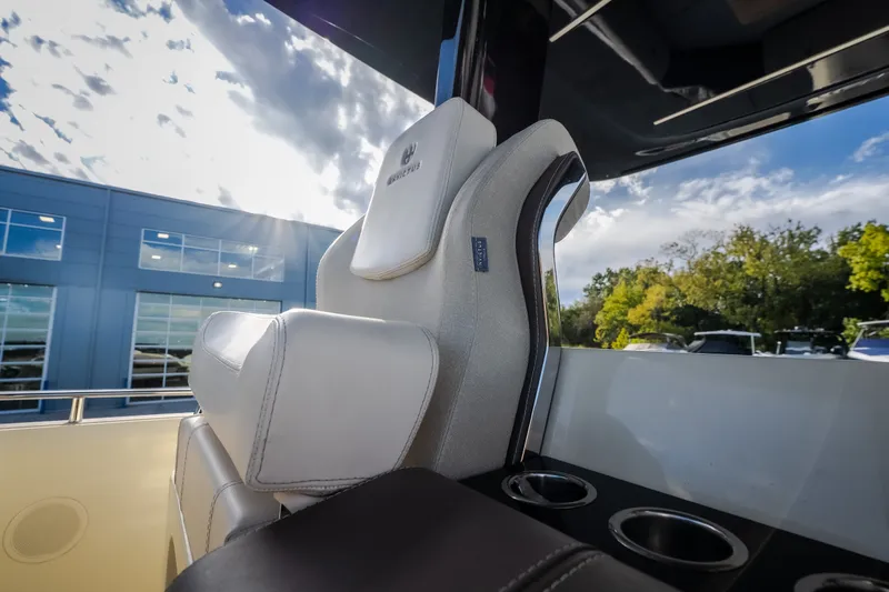 Slide: The Image of 2024 Invictus GT320S luxury boat seat with cup holders, outdoor setting. - 44