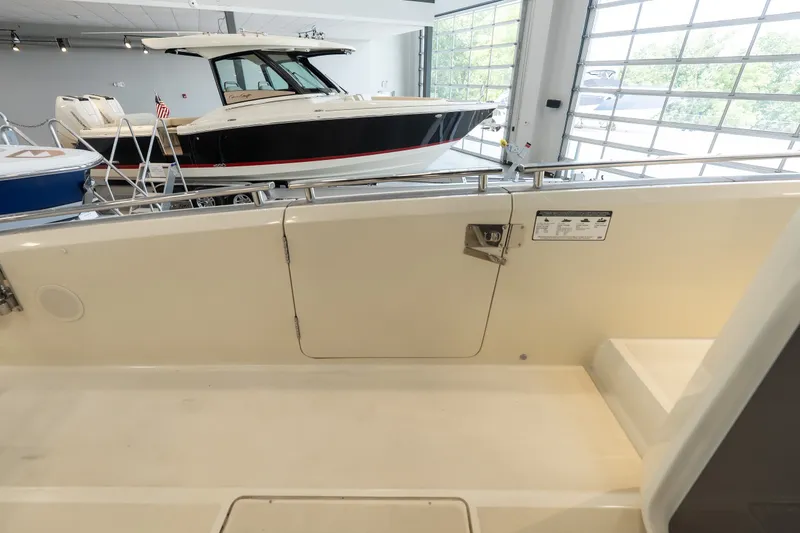 Slide: The Image of 2024 Invictus GT320S boat interior with sleek design in showroom setting. - 37