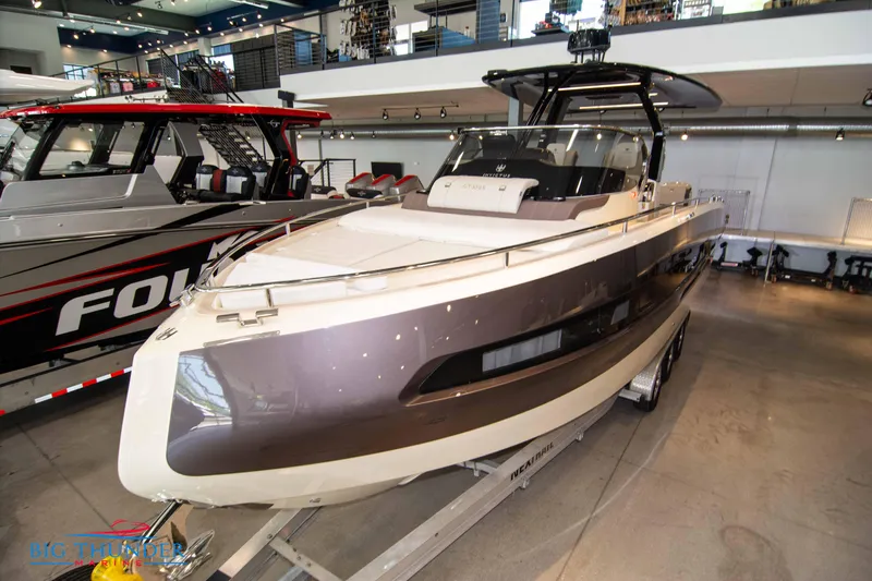 Slide: The Image of 2024 Invictus GT320S luxury boat displayed indoors. - 3