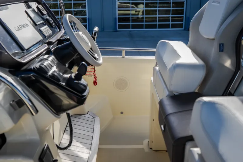 Slide: The Image of 2024 Invictus GT320S boat interior with steering wheel and seating. - 16