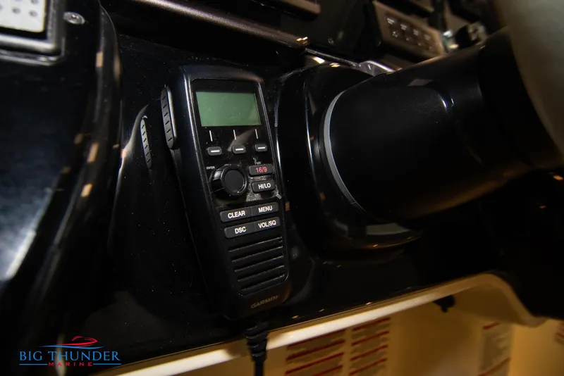 Slide: The Image of VHF radio on the dashboard of a 2024 Invictus GT320S boat. - 37