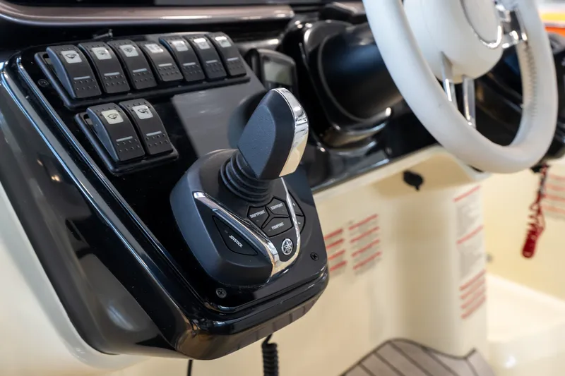 Slide: The Image of Control panel of 2024 Invictus GT320S boat with joystick and switches. - 22