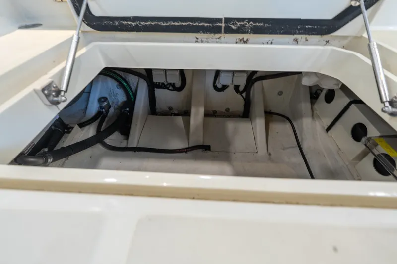 Slide: The Image of Open engine compartment of 2024 Invictus GT320S boat, showcasing internal components and wiring. - 11