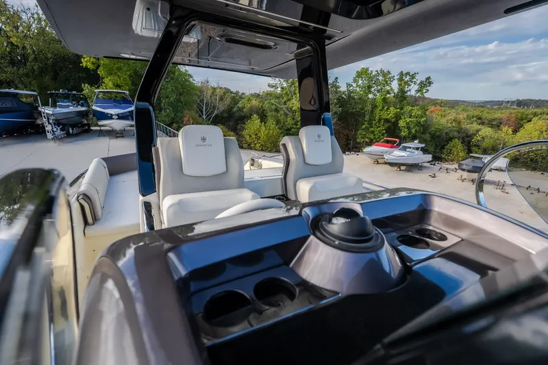 Slide: The Image of 2024 Invictus GT320S boat interior with luxurious seating and modern dashboard. - 30