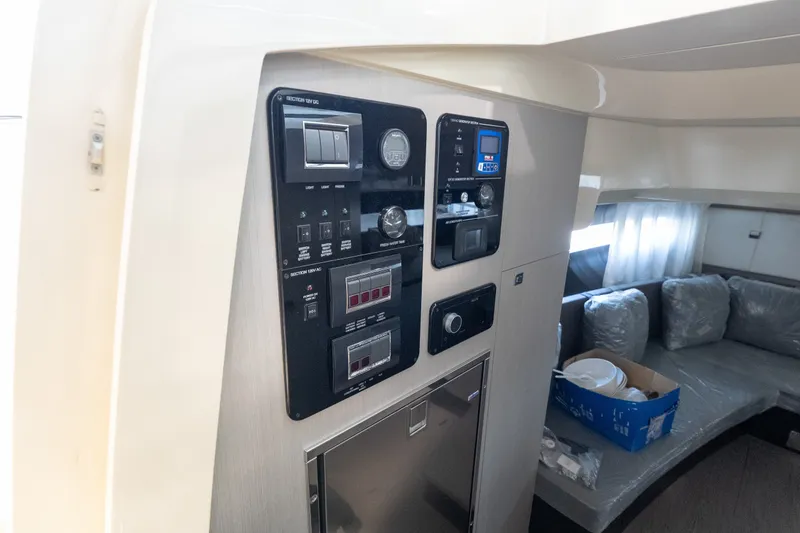 Slide: The Image of Control panel inside 2024 Invictus GT320S yacht, featuring modern interior and seating area. - 26