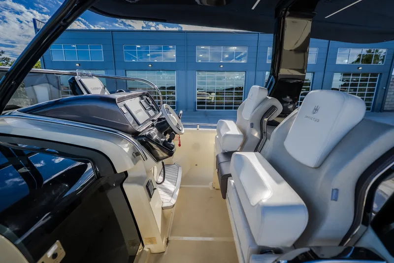 Slide: The Image of 2024 Invictus GT320S boat interior with modern helm and luxurious seating. - 15