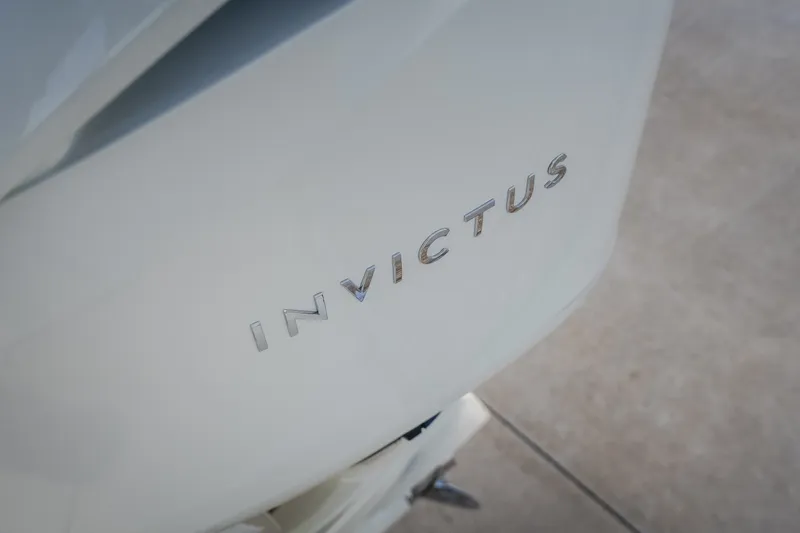 Slide: The Image of 2024 Invictus GT320S logo on sleek white surface. - 58