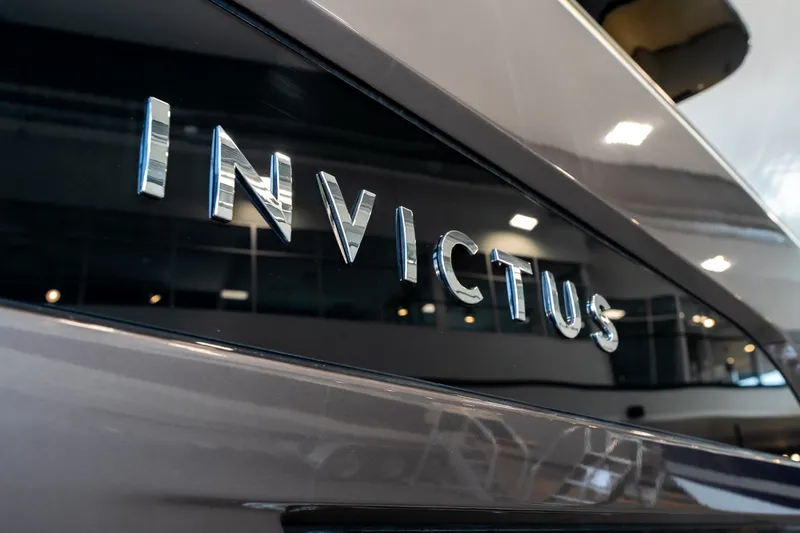 Slide: The Image of 2024 Invictus GT320S yacht with sleek design and chrome lettering. - 2