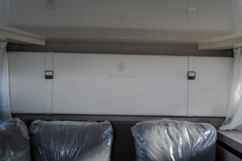 Slide: The Image of Interior of 2024 Invictus GT320S with sleek, modern design and protective seat covers. - 48
