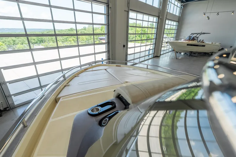 Slide: The Image of 2024 Invictus GT320S luxury boat in a modern showroom with large windows. - 27