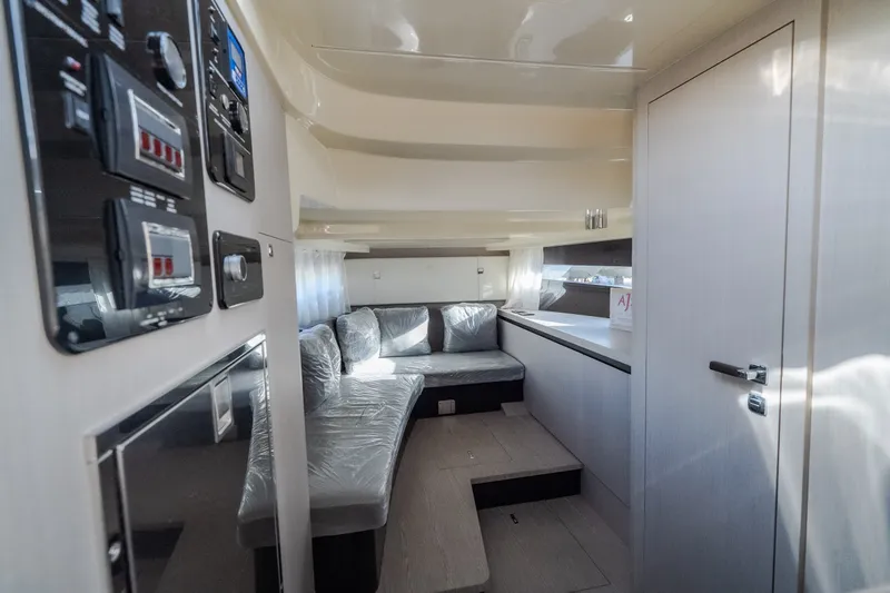 Slide: The Image of 2024 Invictus GT320S yacht interior with modern seating and control panels. - 41