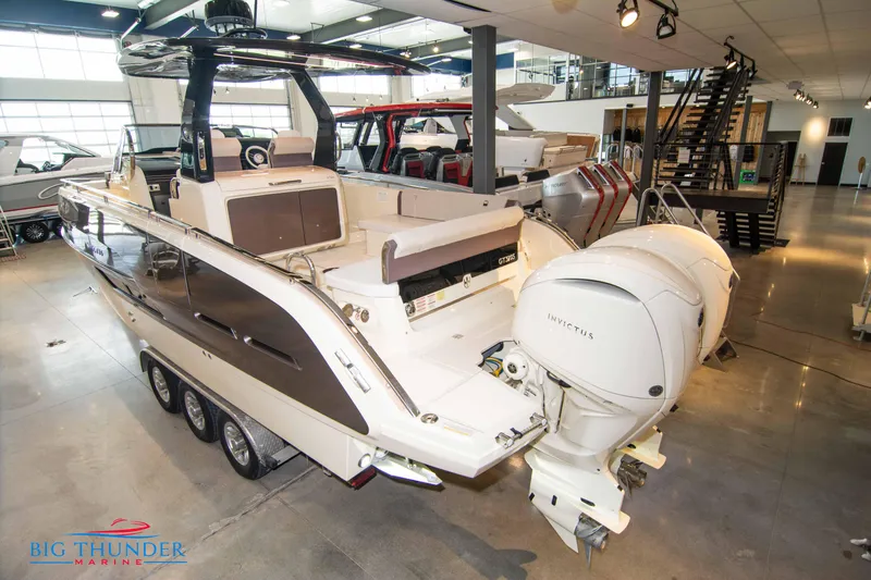 Slide: The Image of 2024 Invictus GT320S luxury motorboat displayed in a showroom. - 6