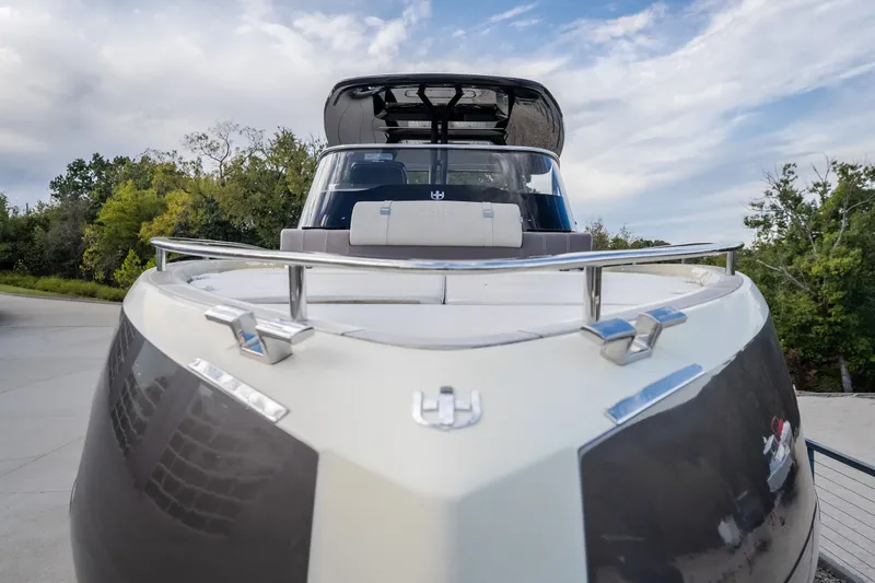 Slide: The Image of 2024 Invictus GT320S luxury boat with sleek design, docked outdoors. - 59