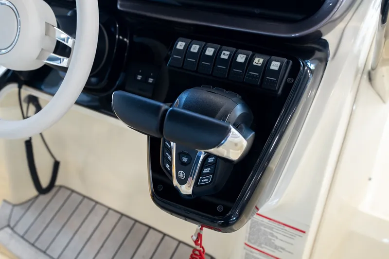 Slide: The Image of 2024 Invictus GT320S boat control panel with steering wheel and throttle lever. - 19
