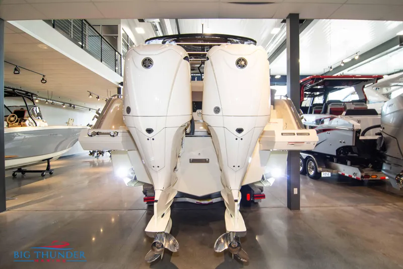 Slide: The Image of 2024 Invictus GT320S luxury boat with twin outboard engines in showroom. - 7