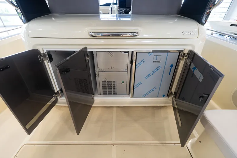 Slide: The Image of 2024 Invictus GT320S yacht interior storage compartments with open doors. - 36