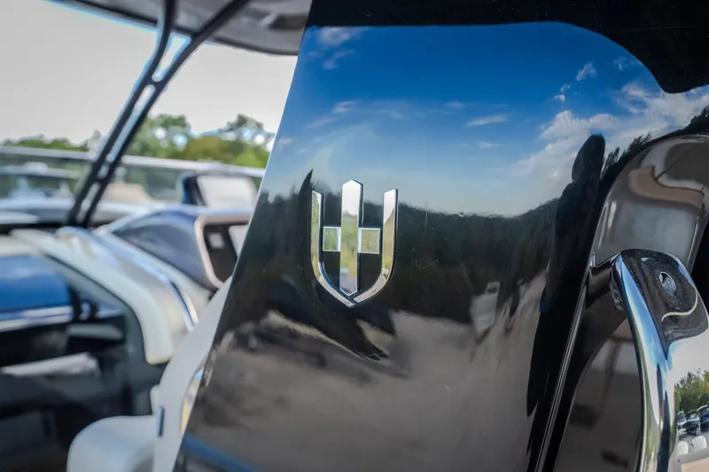 Slide: The Image of 2024 Invictus GT320S boat interior with logo, reflecting blue sky and clouds. - 54