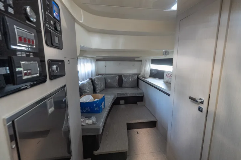Slide: The Image of Interior of 2024 Invictus GT320S yacht, featuring modern seating and control panels. - 24