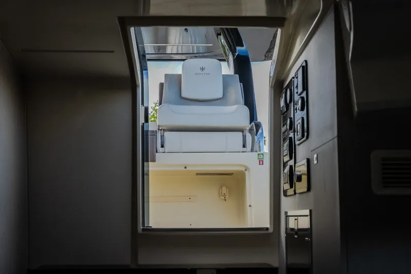 Slide: The Image of Interior view of 2024 Invictus GT320S yacht, showcasing luxurious seating and control panel. - 50