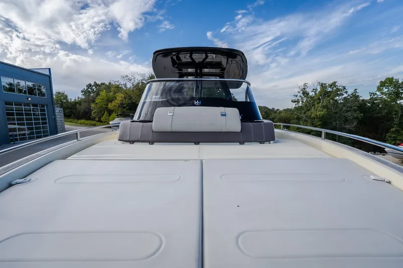 Slide: The Image of 2024 Invictus GT320S yacht deck with sleek design under a blue sky. - 34