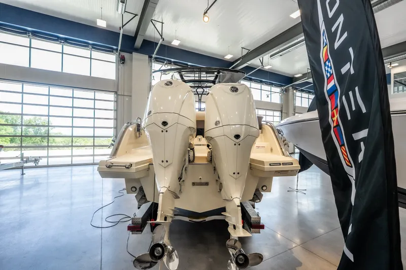 Slide: The Image of 2024 Invictus GT320S boat with dual engines in a showroom setting. - 4