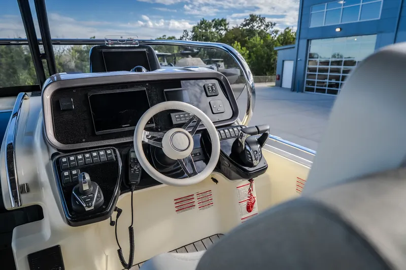 Slide: The Image of 2024 Invictus GT320S boat cockpit with modern steering and control panel. - 22
