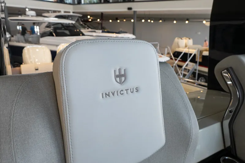 Slide: The Image of 2024 Invictus GT320S boat seat with logo in a showroom setting. - 20