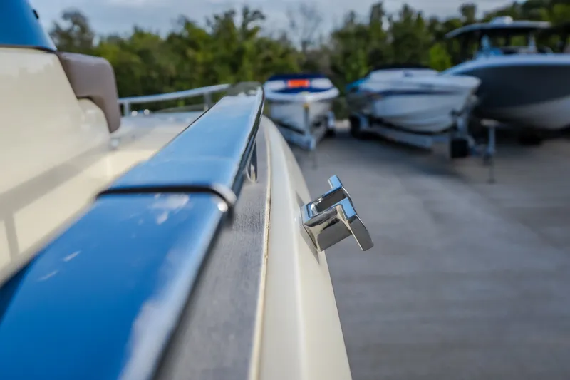 Slide: The Image of Close-up of 2024 Invictus GT320S boat detail with other boats in the background. - 29