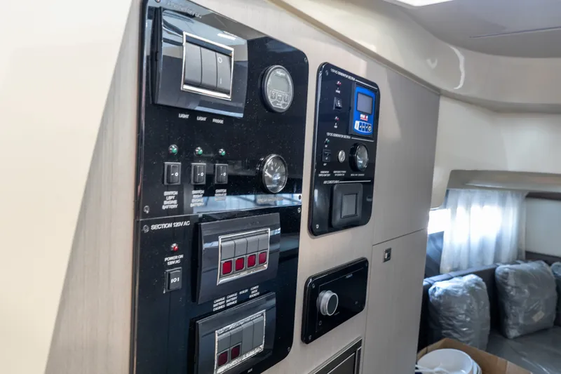Slide: The Image of Control panel inside 2024 Invictus GT320S yacht, featuring switches and gauges. - 23