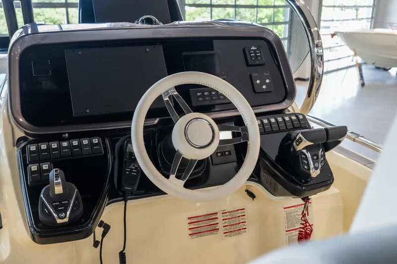 Slide: The Image of 2024 Invictus GT320S boat dashboard with steering wheel and control panel. - 15