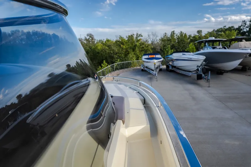 Slide: The Image of 2024 Invictus GT320S boat parked with other boats on a sunny day. - 28