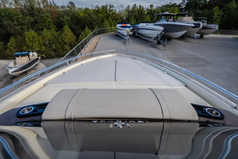 Slide: The Image of 2024 Invictus GT320S boat on trailer, surrounded by trees and other boats. - 31