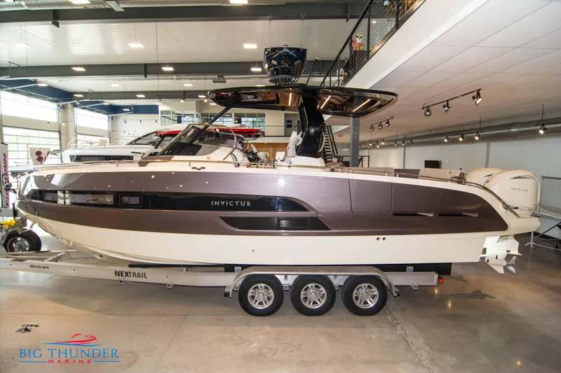 Slide: The Image of 2024 Invictus GT320S luxury boat on a Nextrail trailer in showroom. - 70