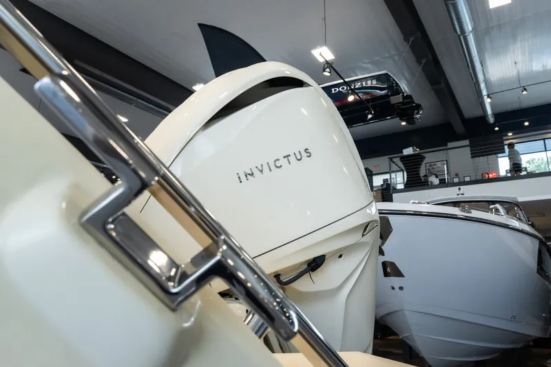 Slide: The Image of 2024 Invictus GT320S boat displayed in a modern showroom setting. - 3