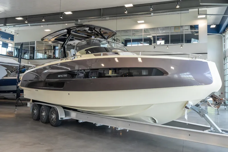 Slide: The Image of 2024 Invictus GT320S luxury yacht displayed indoors on a trailer. - 10