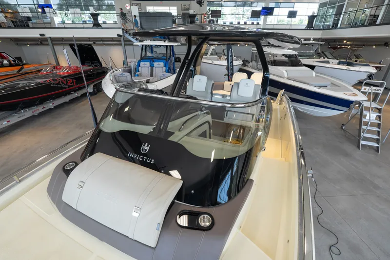 Slide: The Image of 2024 Invictus GT320S luxury boat displayed in a showroom with sleek design and modern features. - 32