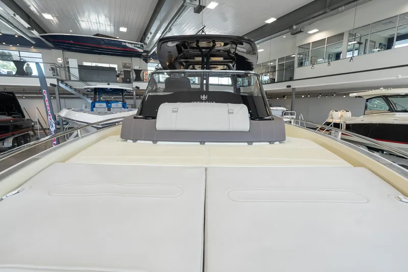 Slide: The Image of 2024 Invictus GT320S luxury boat interior in showroom, showcasing sleek design and spacious seating. - 30