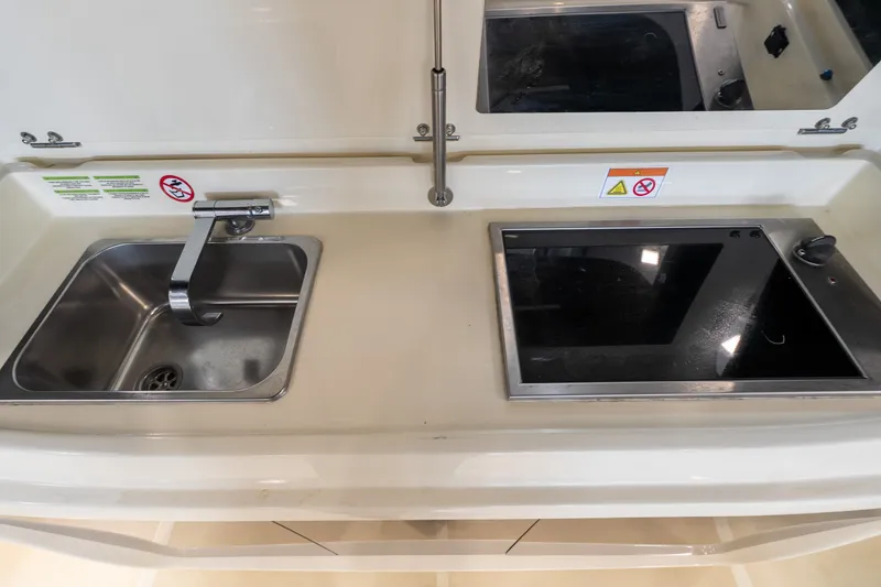 Slide: The Image of Compact kitchen area in 2024 Invictus GT320S with sink and stove. - 35