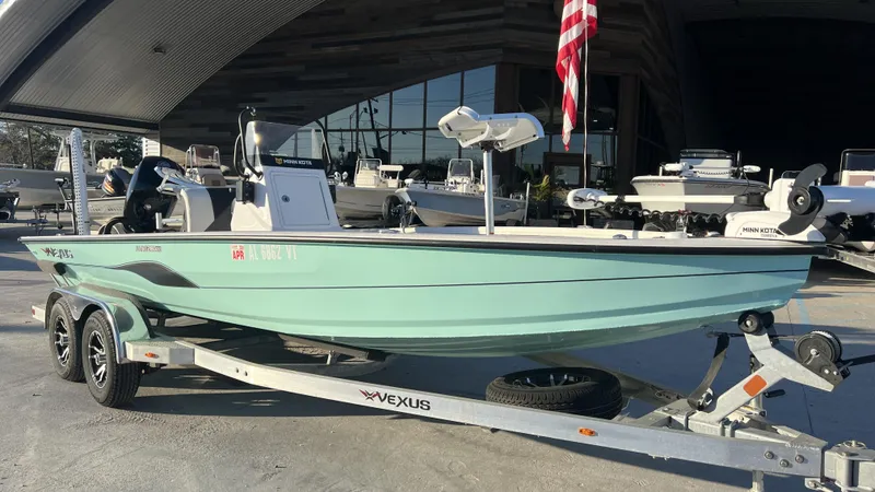 Slide: The Image of 2022 Vexus AVX2180CC boat on trailer, displayed outdoors with American flag. - 7