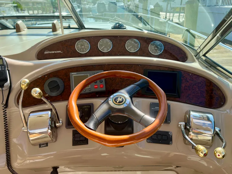 Slide: The Image of 2004 Sea Ray 46 SUNDANCER helm with wooden steering wheel and control panel. - 20