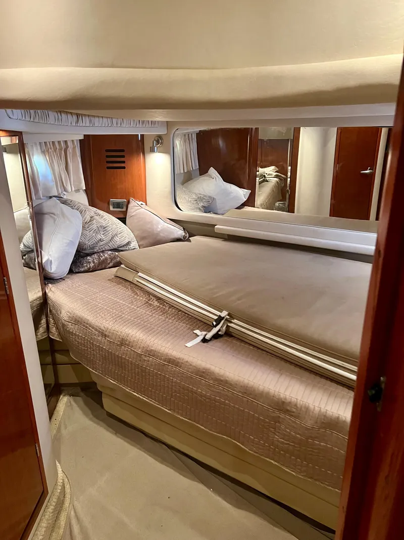Slide: The Image of Luxurious bedroom interior of 2004 Sea Ray 46 Sundancer yacht with cozy bedding. - 23